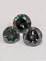 Front view of three round brilliant cut moissanite gemstones