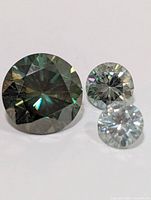 Close-up of three loose moissanite stones