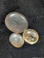 Three cat's eye gemstones on black background