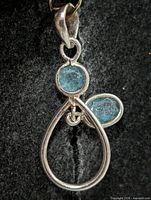 Front view showing pendant design and gemstones
