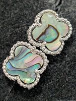 Front view of both earrings showing mother-of-pearl and silver edging
