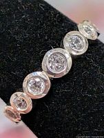 Close-up of ring front showing bezel-set CZ stones