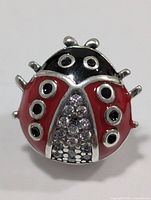 Front view showing ladybug design, enamel colours and crystals
