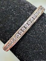 Close-up of channel-set CZ stones on silver band