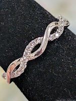 Front angled view showing twisted band with cubic zirconia