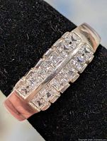 Top view of silver ring displaying channel-set cubic zirconia stones