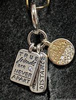 Full view of pendant showing all three charms and bail