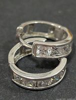 Both silver hoop earrings stacked showing channel-set CZ stones