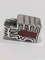 Side view of bead showing red enamel tree design and 925 stamp