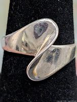 Front view of silver wrap ring on display