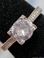 Front view of silver ring with large round CZ center stone