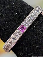 Close-up of channel-set CZ stones and pink accent