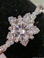 Front view of ring showing center CZ, halo stones and twisted shank