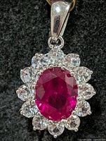 Front view showing ruby centre and CZ halo