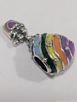 Full view of silver charm bead showing multicolour enamel stripes and bail