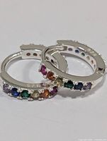 Close-up of both silver hoops showing multicoloured stones front view