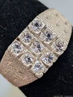 Front view showing 3x3 clear stone cluster on silver textured band