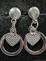 front view of earrings showing stud, ring and heart charm design