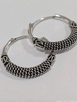 front view of both hoop earrings showing twisted wire coil design