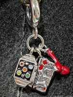 Front view showing all three charms and bail