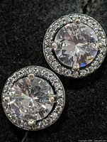 Front view of both halo CZ stud earrings