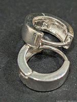 Close-up of both earrings latched together showing overall design and closure mechanism