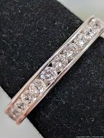 Close-up of channel-set CZ stones on the silver band