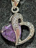 Front view of silver heart pendant with purple CZ stone and clear CZ accents