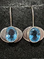 Front view showing both earrings with stones and metal finish