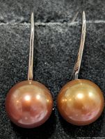 Front view of both earrings showing pearl colour and silver hooks