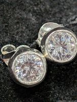 front view of both earrings showing CZ stones and bezel setting