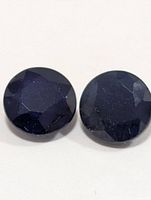 close-up of both round dark blue stones