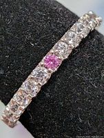 Side view of eternity band showing clear and pink CZ stones
