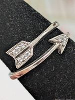 Front view of silver arrow ring showing CZ-set arrow head and tail