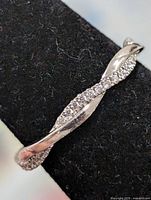 Close-up of ring on mandrel showing twisted CZ design