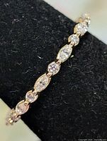 Side view of sterling silver ring showing alternating marquise and round CZ stones