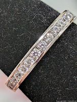 Close-up of cubic zirconia channel setting on silver band