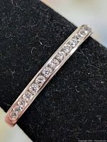 Close-up of channel-set CZ stones in silver band