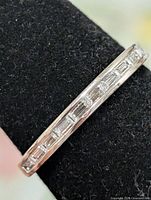Oblique view of ring showing channel-set baguette CZ stones