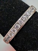 Top view of silver band ring showing channel-set CZ stones