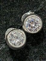 Front view of both earrings showing bezel-set stones