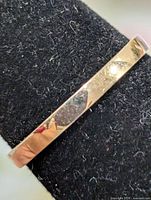 Side view of silver band ring on stand