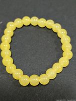 Top view of entire yellow calcite bracelet showing bead count and color