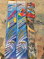 Front view of all three packaged kites side by side