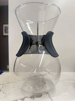 Front view of glass pour-over coffee maker showing silicone grip
