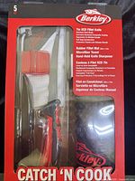 Front of sealed Berkley Catch 'N Cook kit showing knife, mat, towel, sharpener