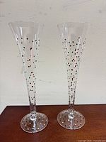 Pair of speckled champagne flutes standing side-by-side
