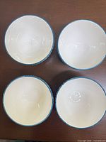 Top view of four ceramic dessert bowls showing interiors