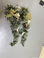 Full view of flocked pine garland swag with bows and ornaments