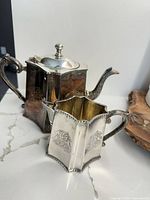 Teapot and creamer showing overall design and size